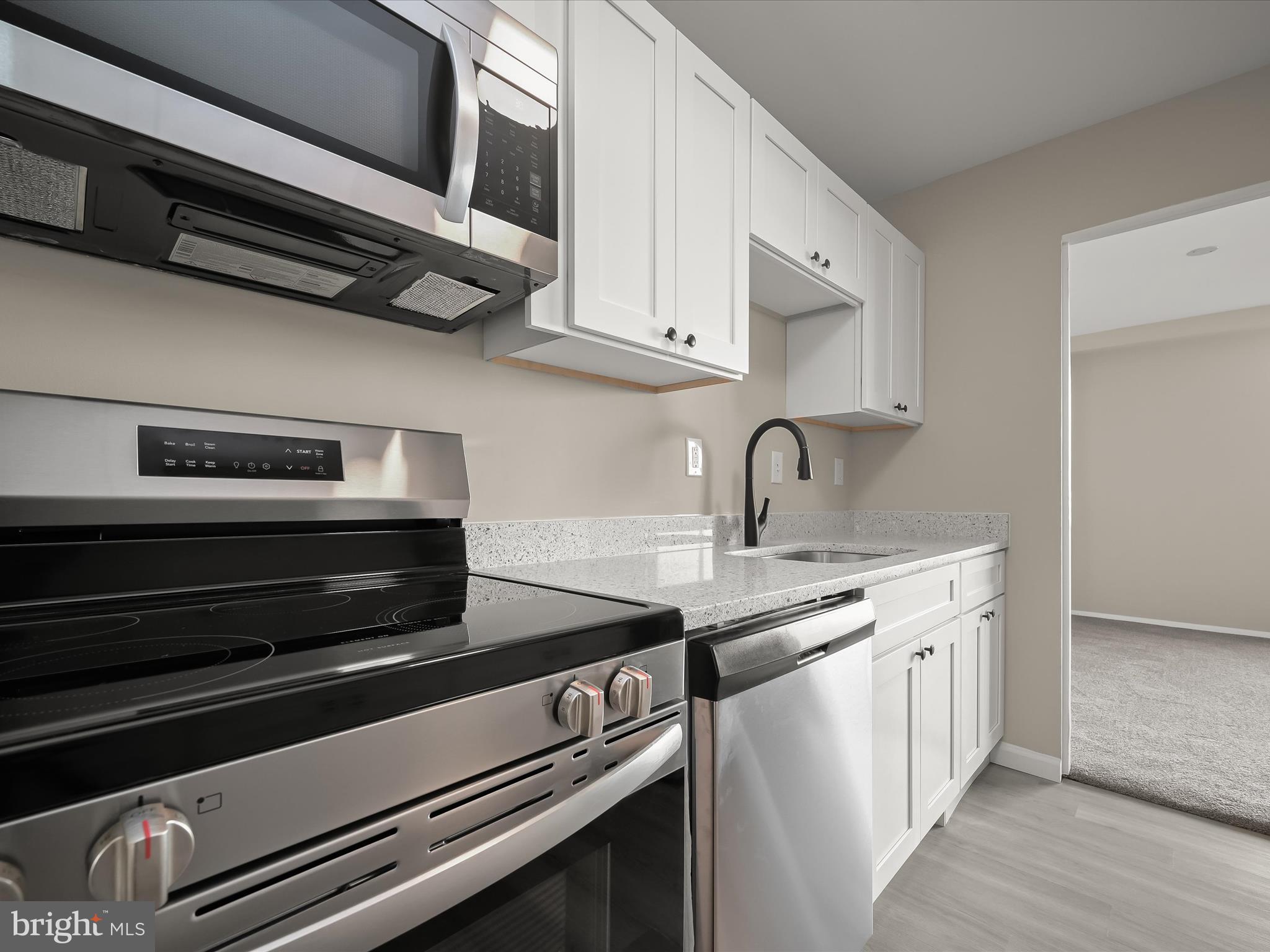 9701 Fields Road, Unit 1607 Gaithersburg, MD 20878 - Photo 12 of 42 a kitchen with stainless steel appliances granite countertop a sink and cabinets