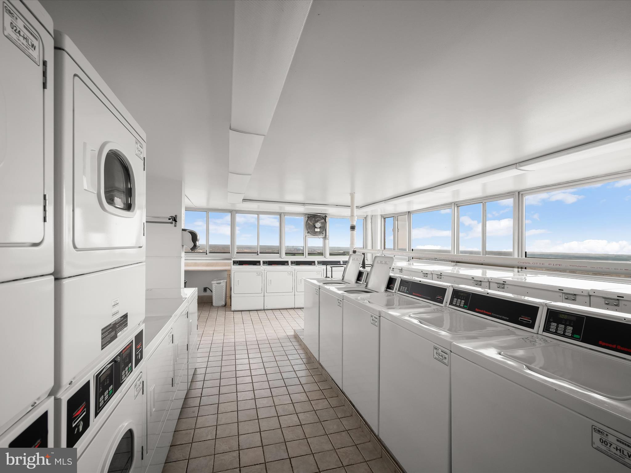 9701 Fields Road, Unit 1607 Gaithersburg, MD 20878 - Photo 26 of 42 a kitchen with stainless steel appliances a white refrigerator a sink a stove and white cabinets