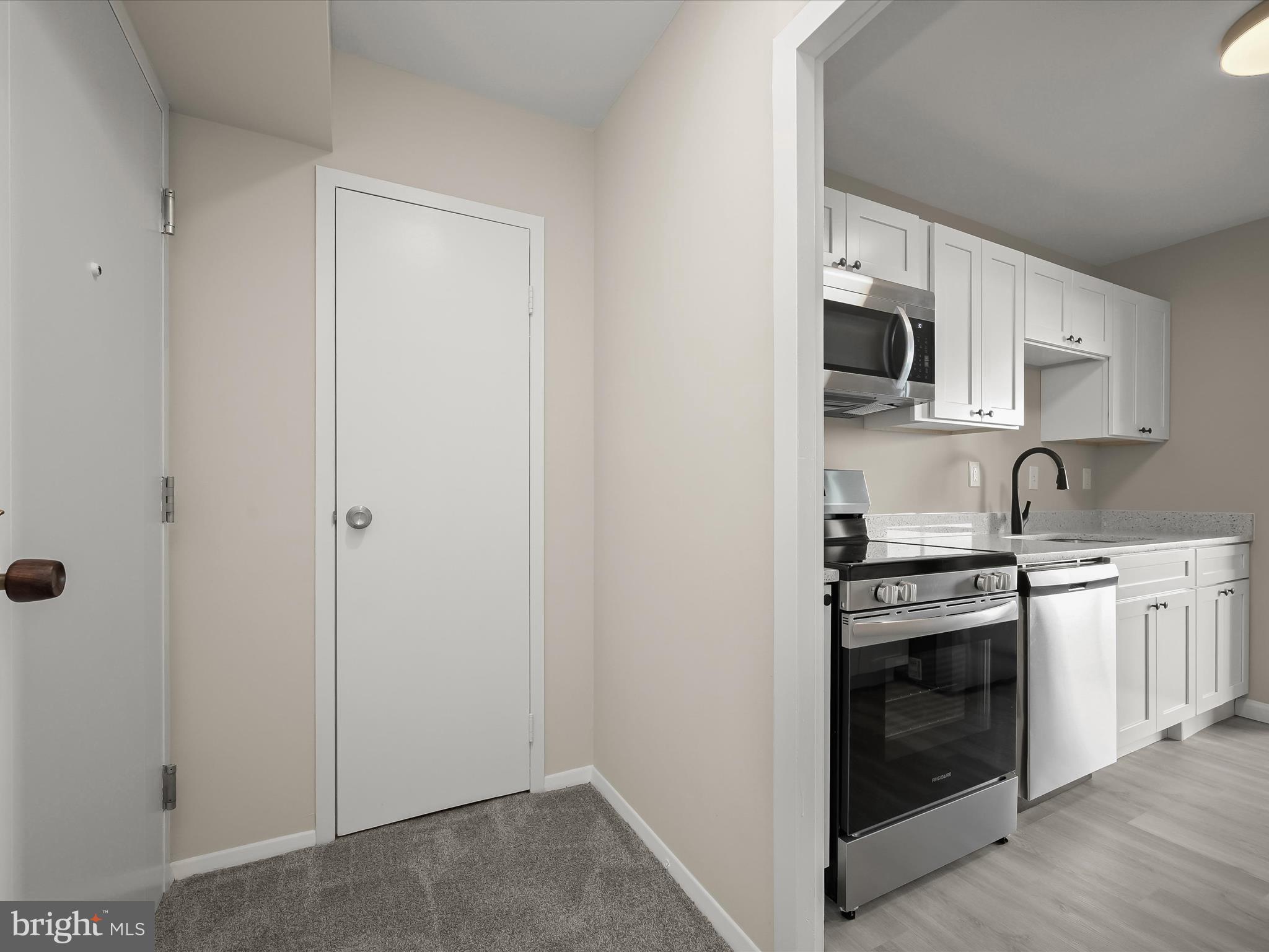 9701 Fields Road, Unit 1607 Gaithersburg, MD 20878 - Photo 7 of 42 a view of a kitchen with a sink stove and cabinets