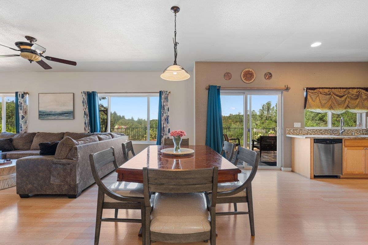 23392 Meyer Ravine Road Grass Valley, CA 95949 - Photo 12 of 58 a living room with furniture a window and a dining table