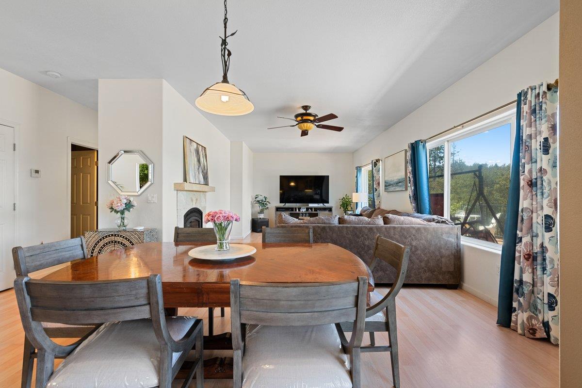 23392 Meyer Ravine Road Grass Valley, CA 95949 - Photo 13 of 58 a dining room with furniture a chandelier and wooden floor