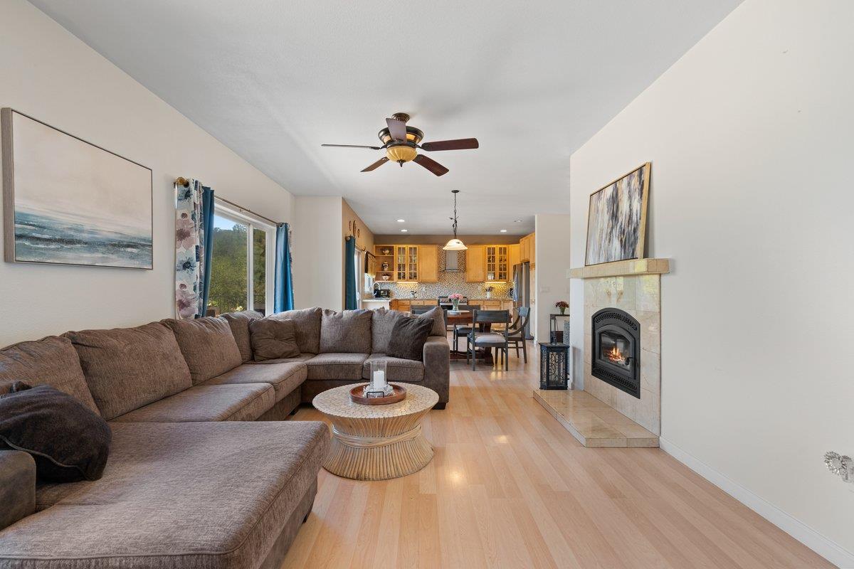 23392 Meyer Ravine Road Grass Valley, CA 95949 - Photo 14 of 58 a living room with furniture a fireplace and a chandelier