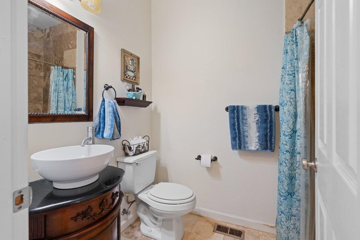 23392 Meyer Ravine Road Grass Valley, CA 95949 - Photo 15 of 58 a bathroom with a toilet a sink and a mirror