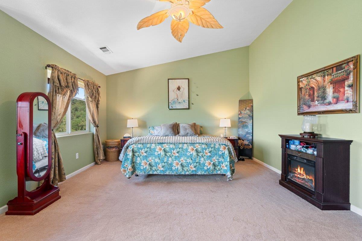 23392 Meyer Ravine Road Grass Valley, CA 95949 - Photo 16 of 58 a bedroom with a bed and a painting on the wall