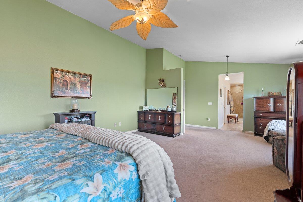 23392 Meyer Ravine Road Grass Valley, CA 95949 - Photo 17 of 58 a bedroom with a bed and a chandelier