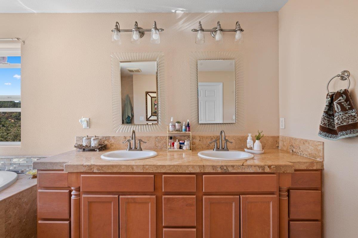 23392 Meyer Ravine Road Grass Valley, CA 95949 - Photo 20 of 58 a bathroom with a granite countertop sink and a mirror