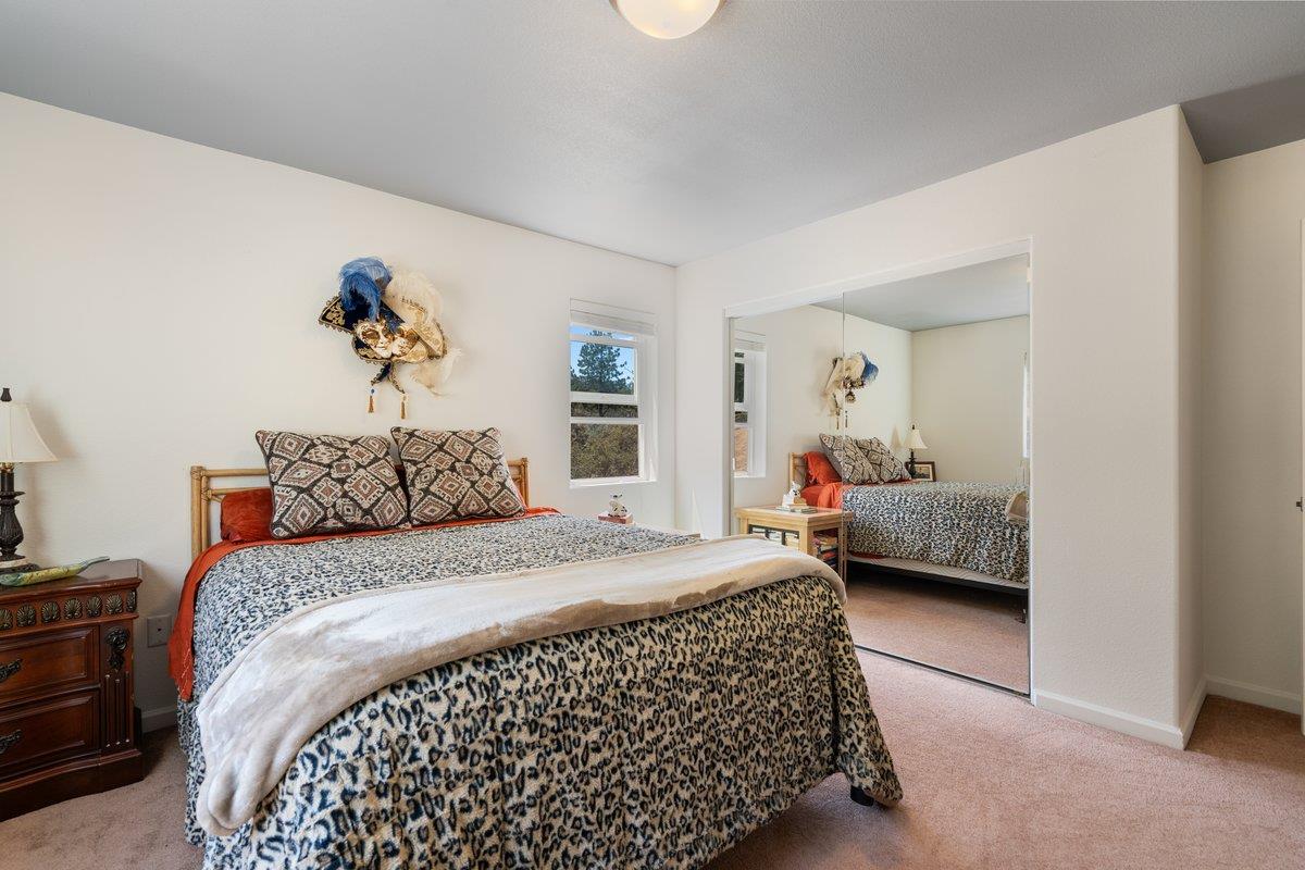 23392 Meyer Ravine Road Grass Valley, CA 95949 - Photo 22 of 58 a bedroom with a bed and a couch