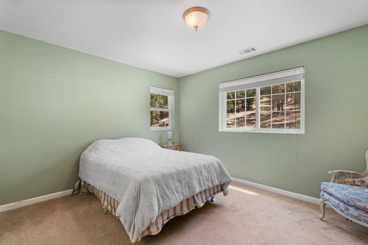 23392 Meyer Ravine Road Grass Valley, CA 95949 - Photo 23 of 58 a bedroom with a bed and a window