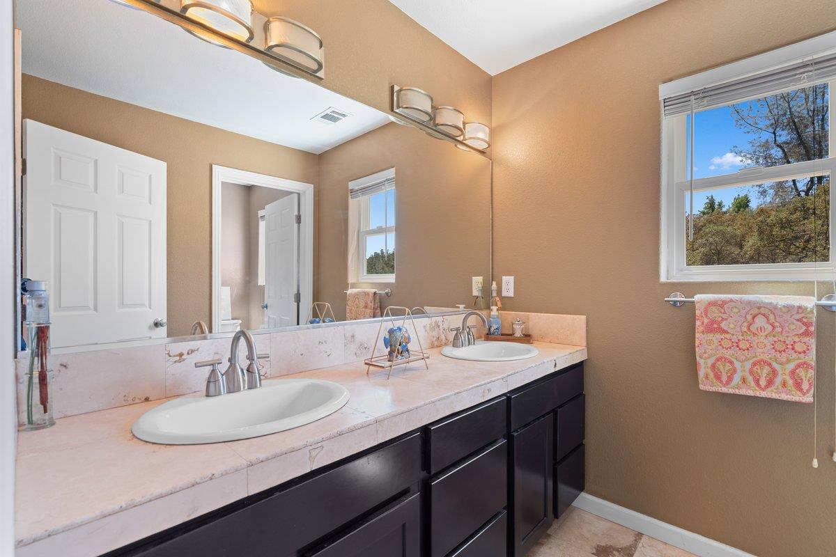 23392 Meyer Ravine Road Grass Valley, CA 95949 - Photo 27 of 58 a bathroom with a sink and a mirror