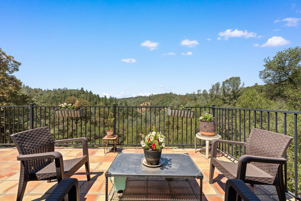 23392 Meyer Ravine Road Grass Valley, CA 95949 - Photo 32 of 58 a view of a chairs and table on the terrace