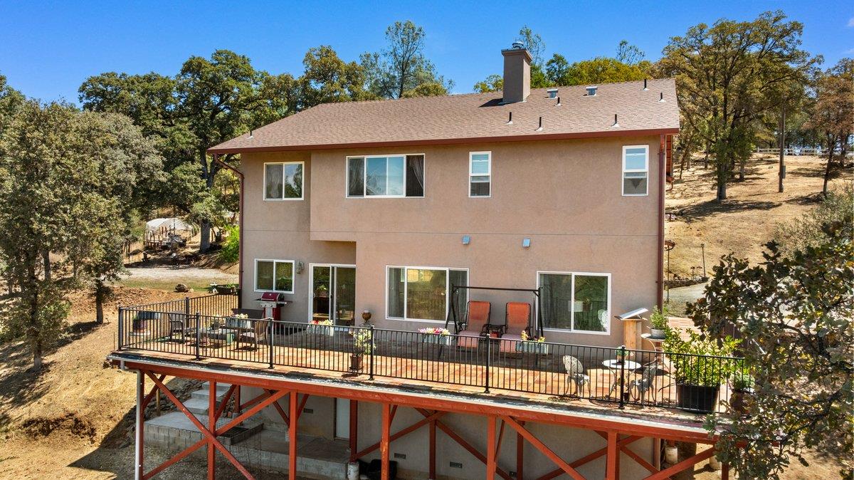 23392 Meyer Ravine Road Grass Valley, CA 95949 - Photo 35 of 58 a backyard of a house with table and chairs