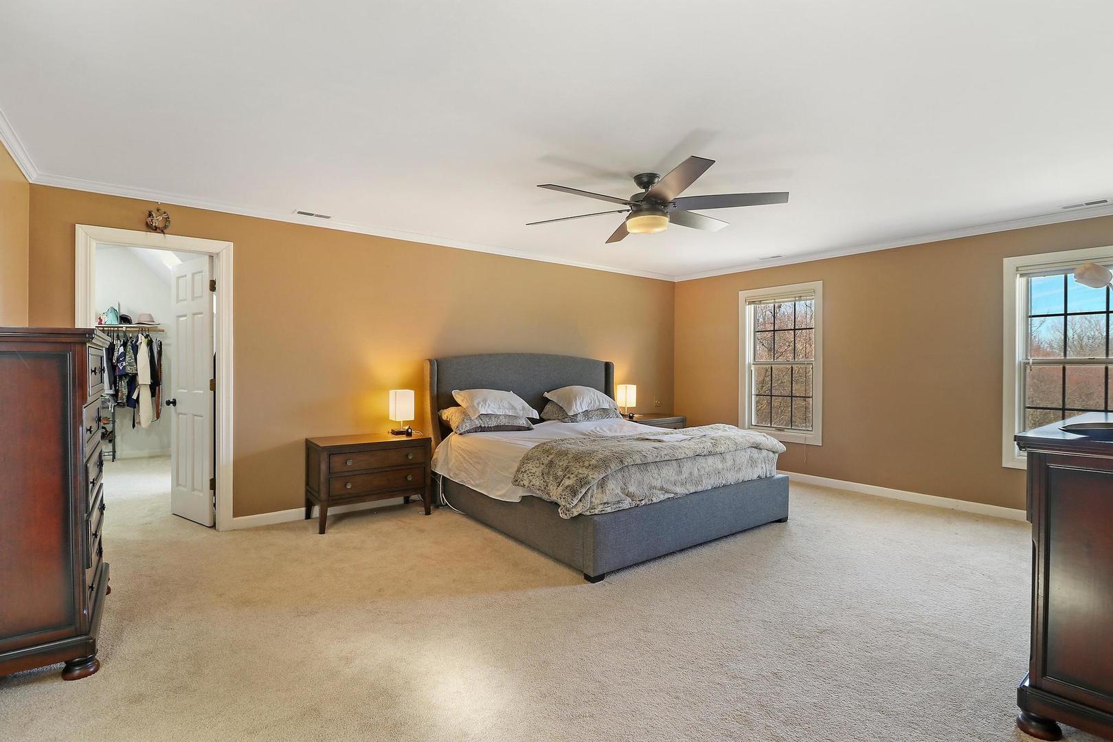 159 Helm Road Barrington Hills, IL 60010 - Photo 31 of 57 a bedroom with a bed and a chandelier