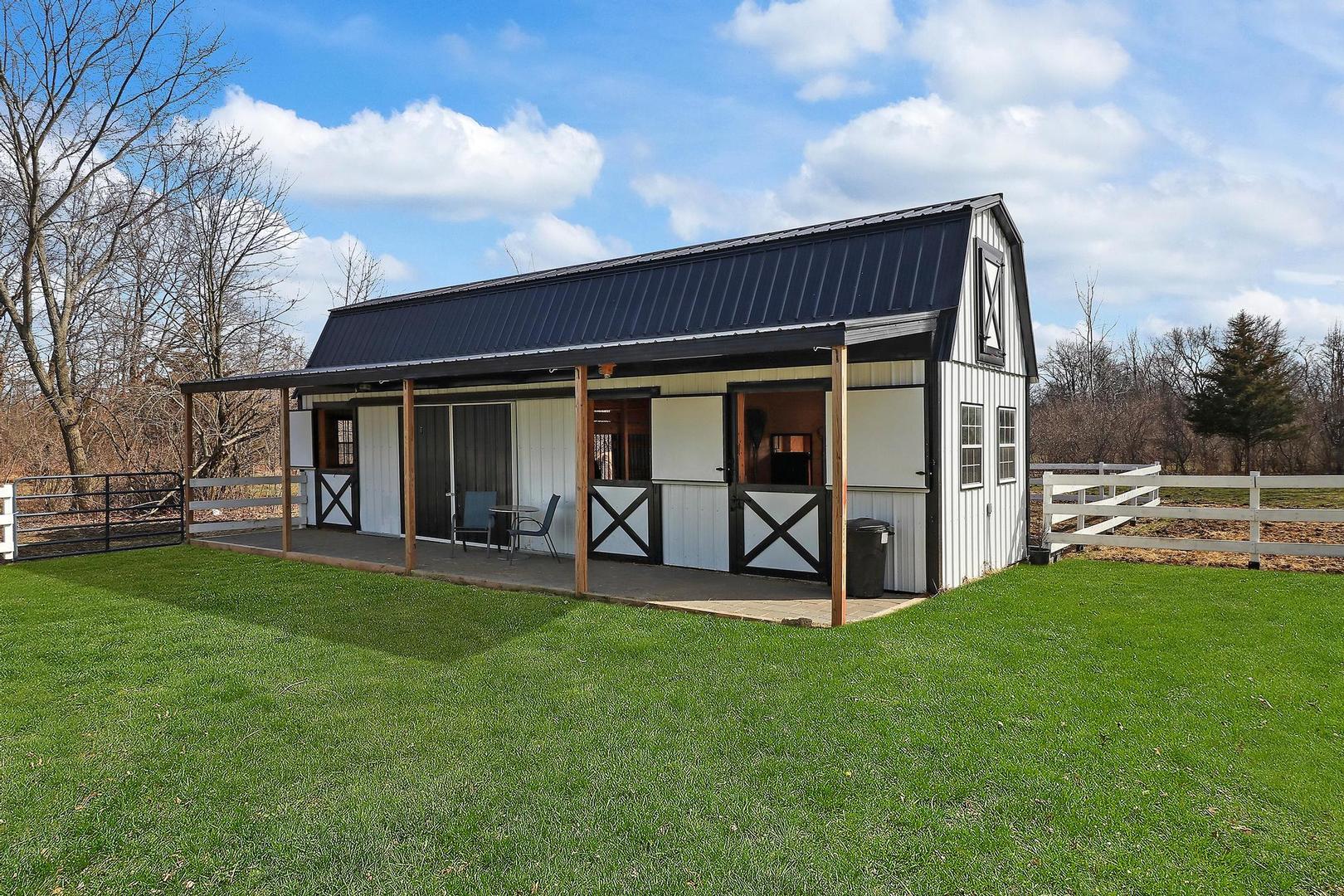 159 Helm Road Barrington Hills, IL 60010 - Photo 51 of 57 a view of a backyard with table and chairs and wooden fence