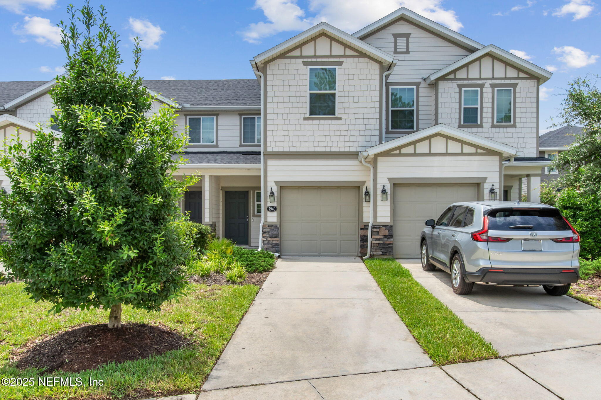 a front view of a house with a yard and garage