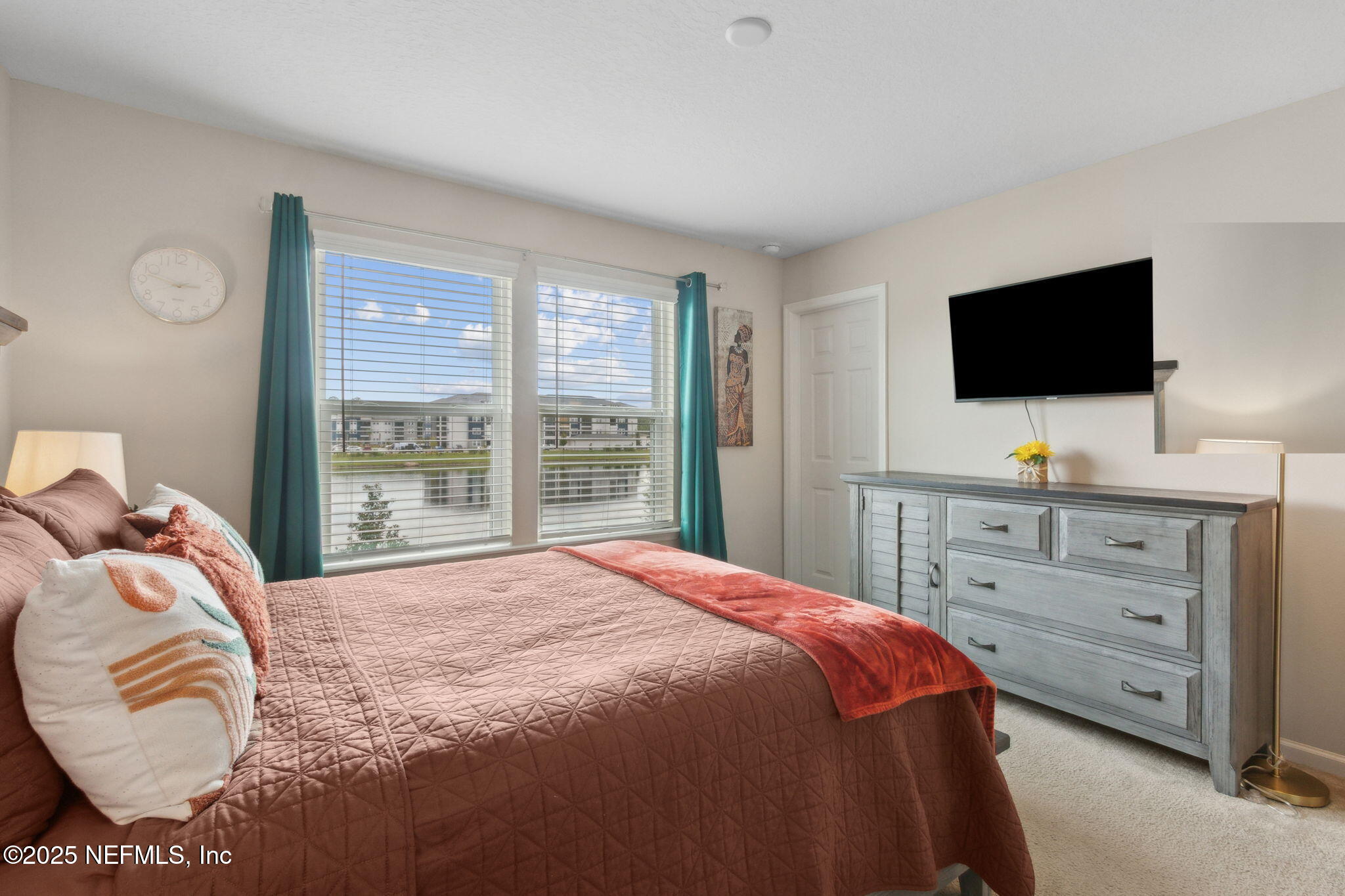 7940 Merchants Way Jacksonville, FL 32222 - Photo 23 of 51 a bedroom with a bed and flat screen tv