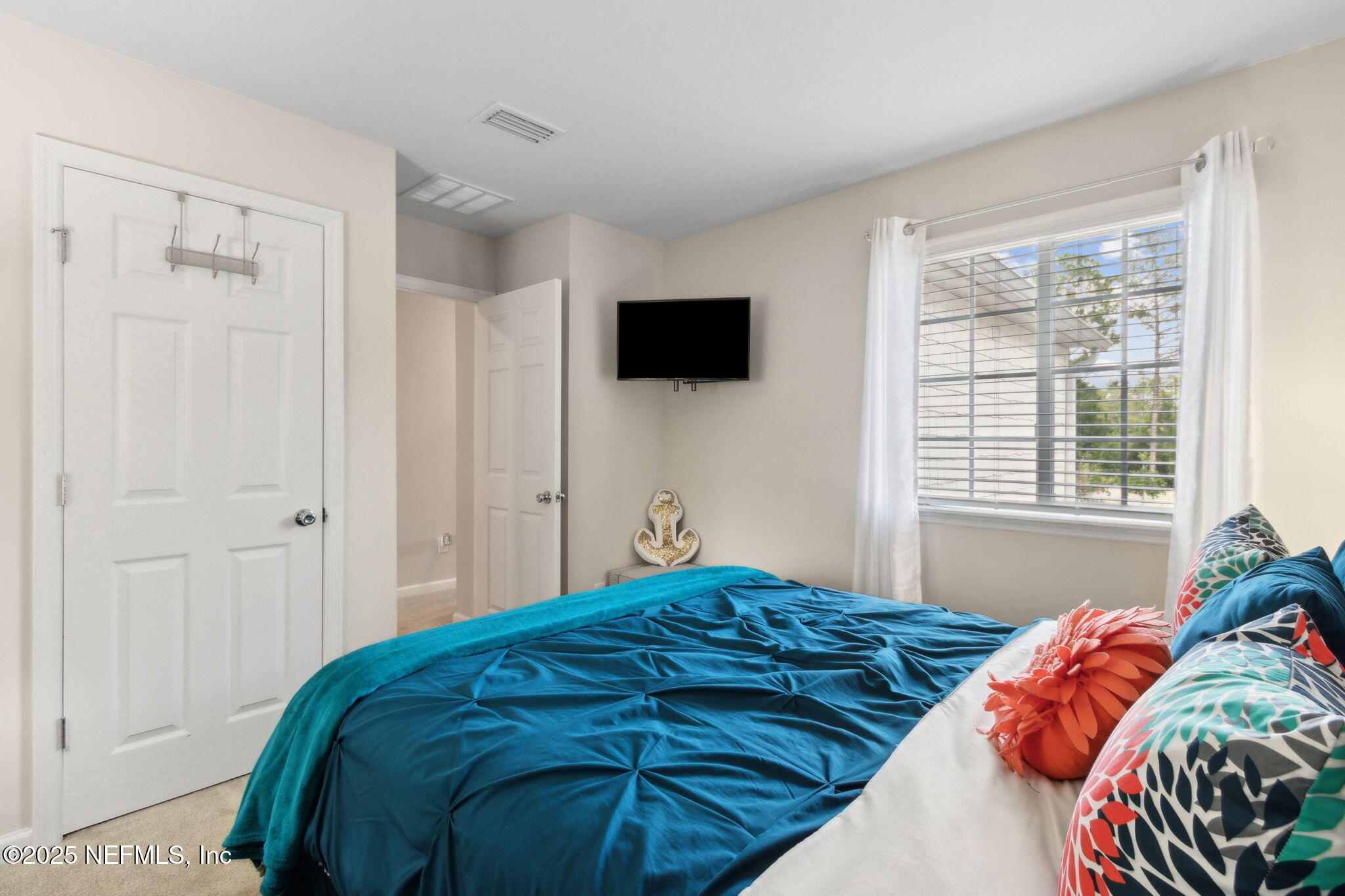 7940 Merchants Way Jacksonville, FL 32222 - Photo 32 of 51 a bedroom with a bed and a television