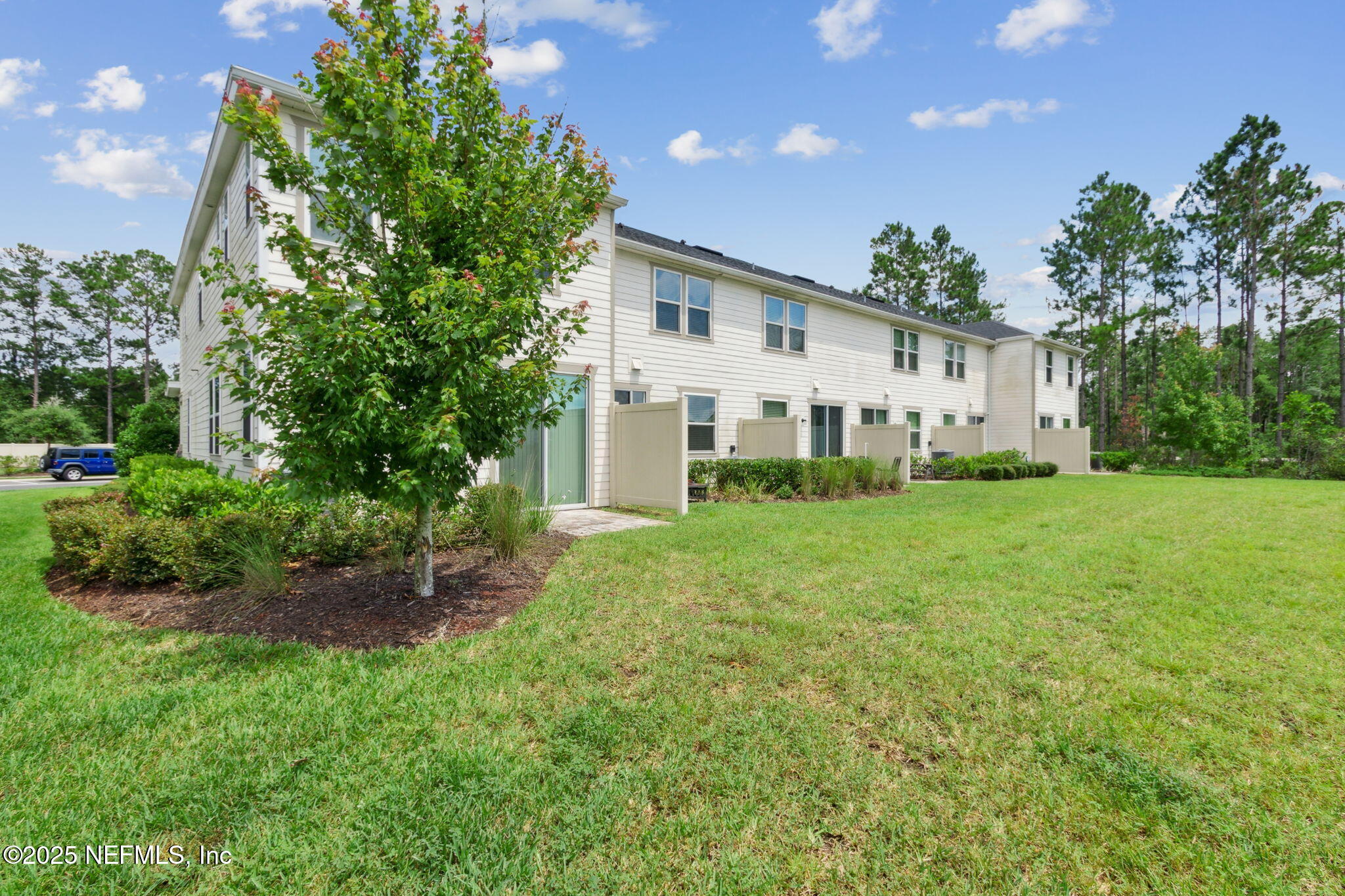 7940 Merchants Way Jacksonville, FL 32222 - Photo 37 of 51 a front view of a house with a yard and trees