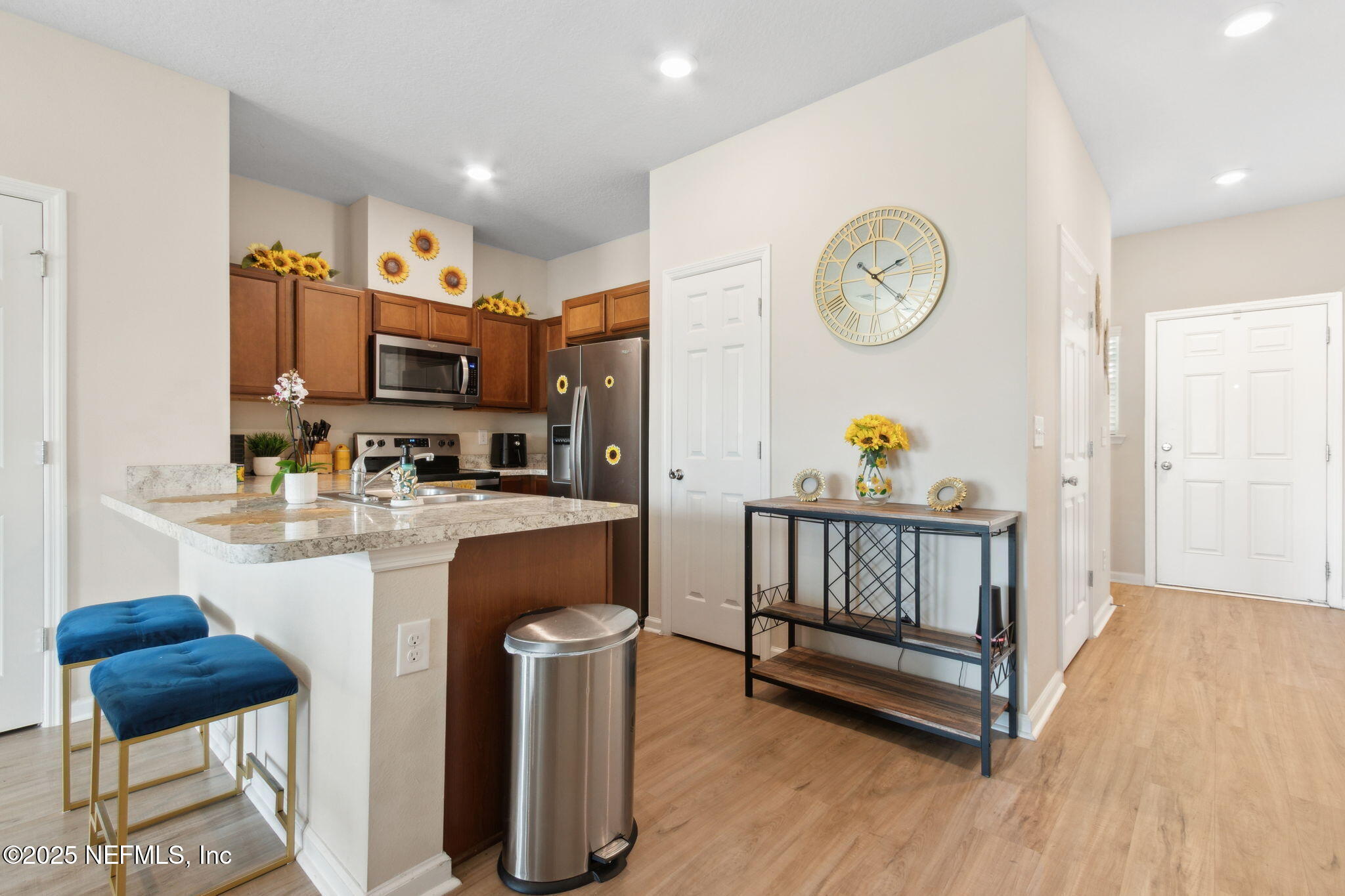 7940 Merchants Way Jacksonville, FL 32222 - Photo 8 of 51 a kitchen with stainless steel appliances granite countertop a microwave a stove and white cabinets
