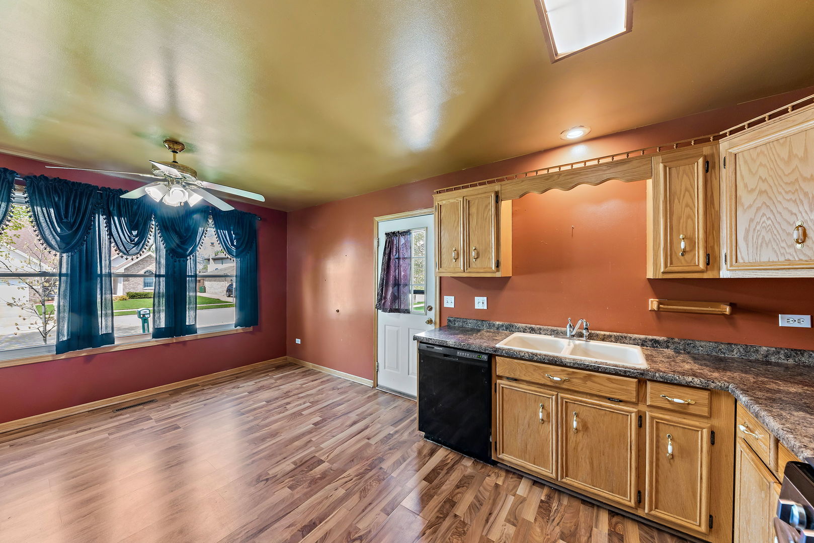 372 Jefferson Street Manteno, IL 60950 - Photo 7 of 24 a kitchen with stainless steel appliances granite countertop a sink cabinets wooden floor and a window