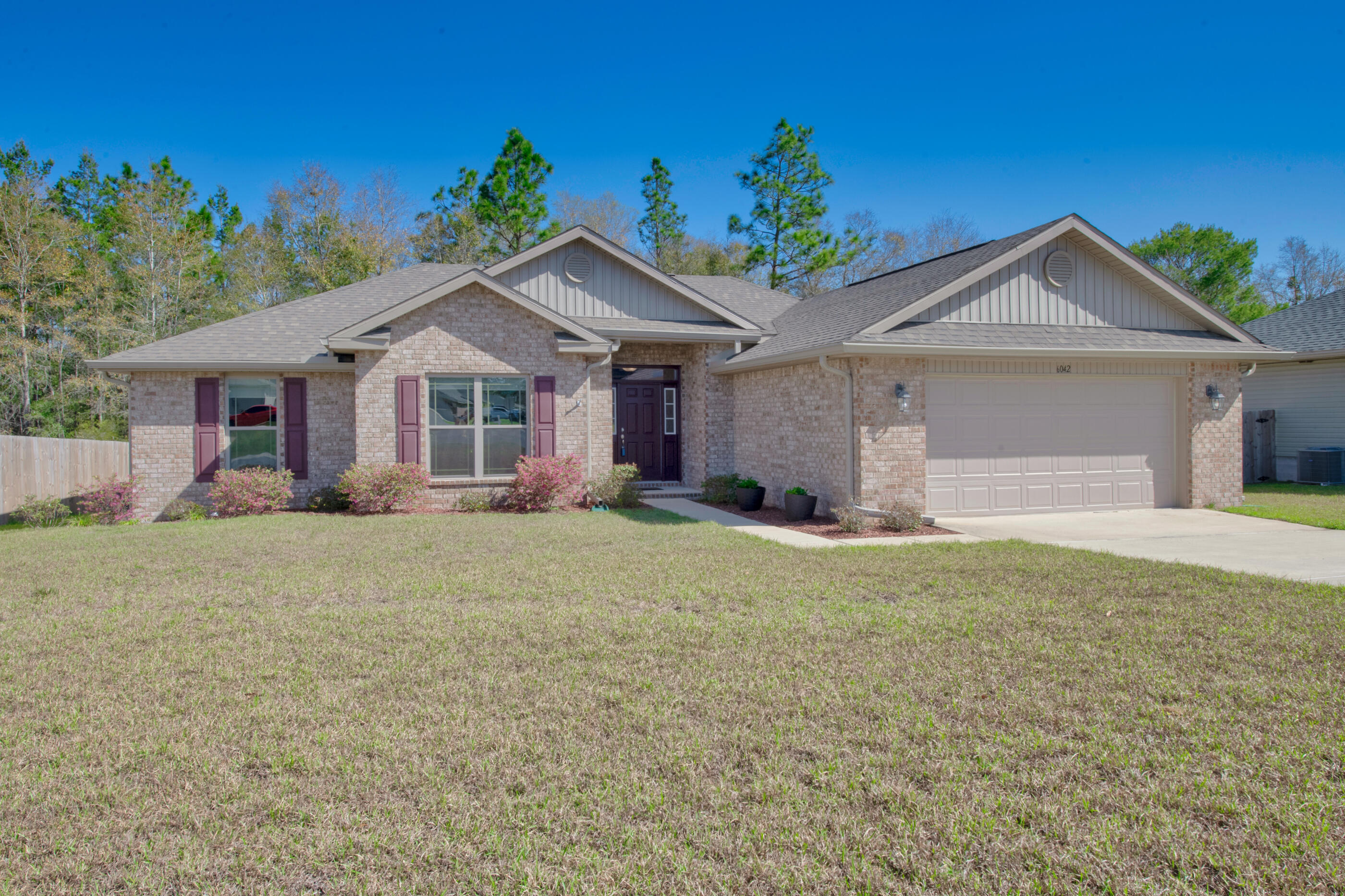 6042 Hidden Valley Road Crestview, FL 32539 - Photo 1 of 34 a view of a house with a yard and potted plants