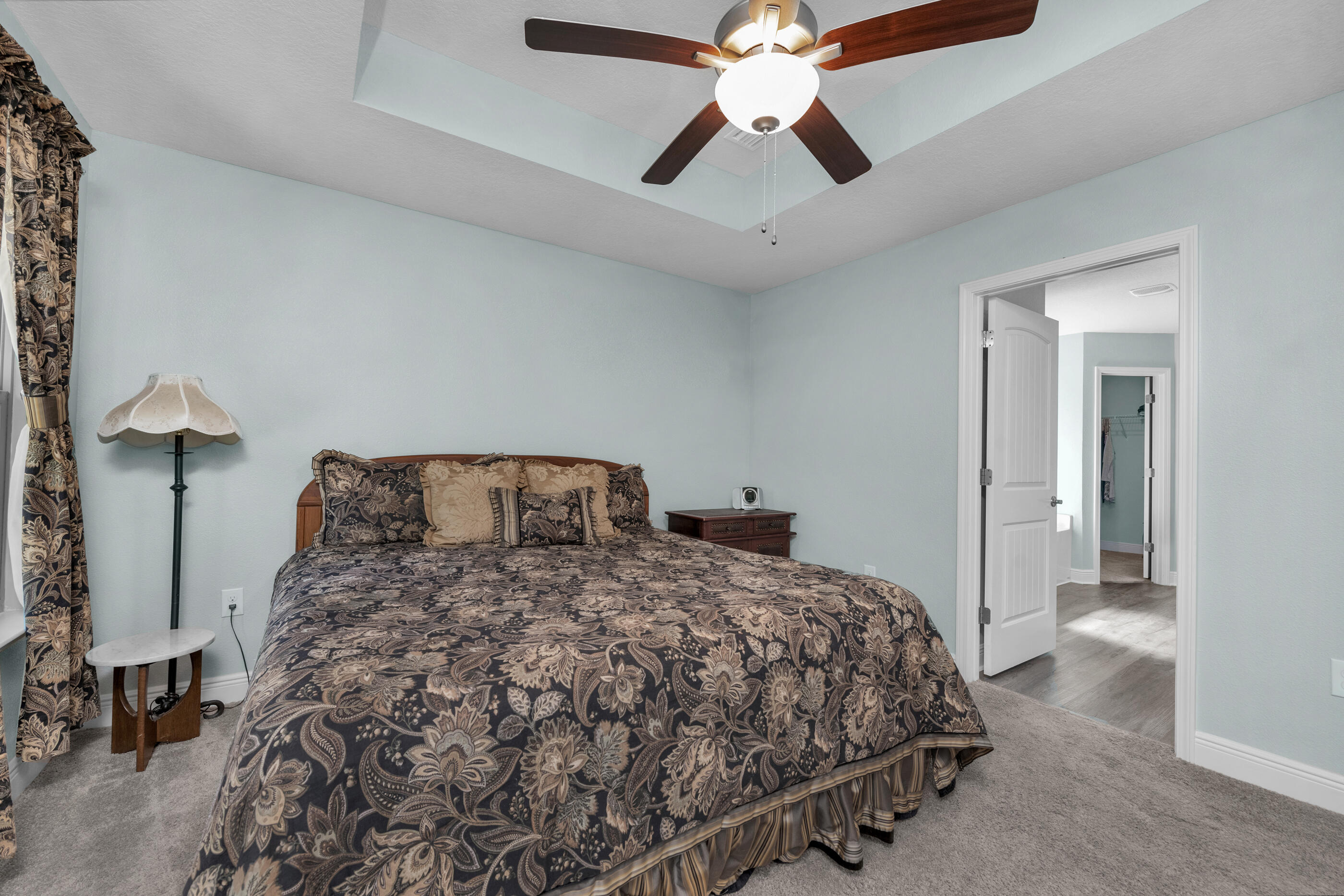 6042 Hidden Valley Road Crestview, FL 32539 - Photo 16 of 34 a bedroom with a bed and a chandelier