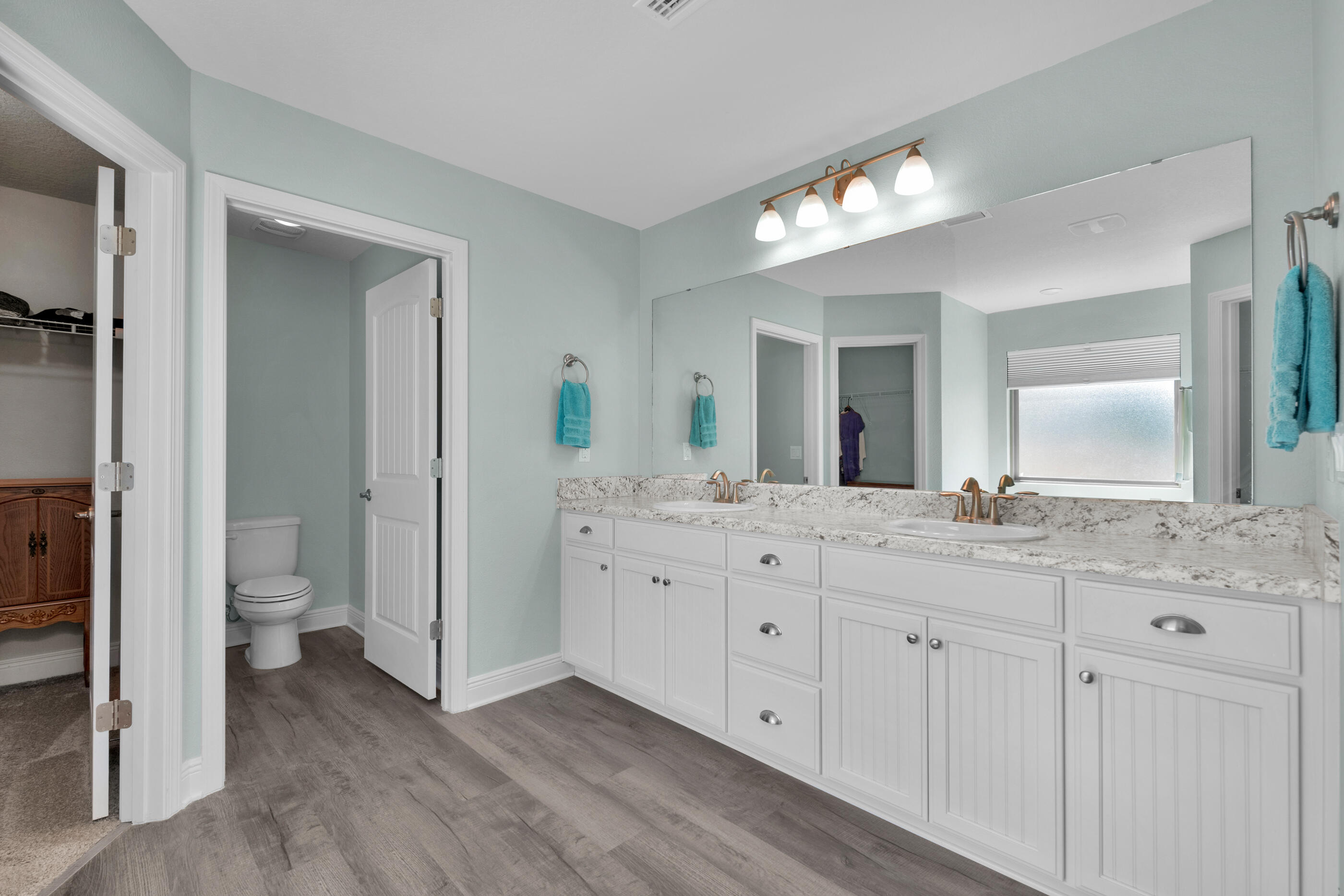 6042 Hidden Valley Road Crestview, FL 32539 - Photo 20 of 34 a bathroom with a granite countertop sink mirror and a toilet