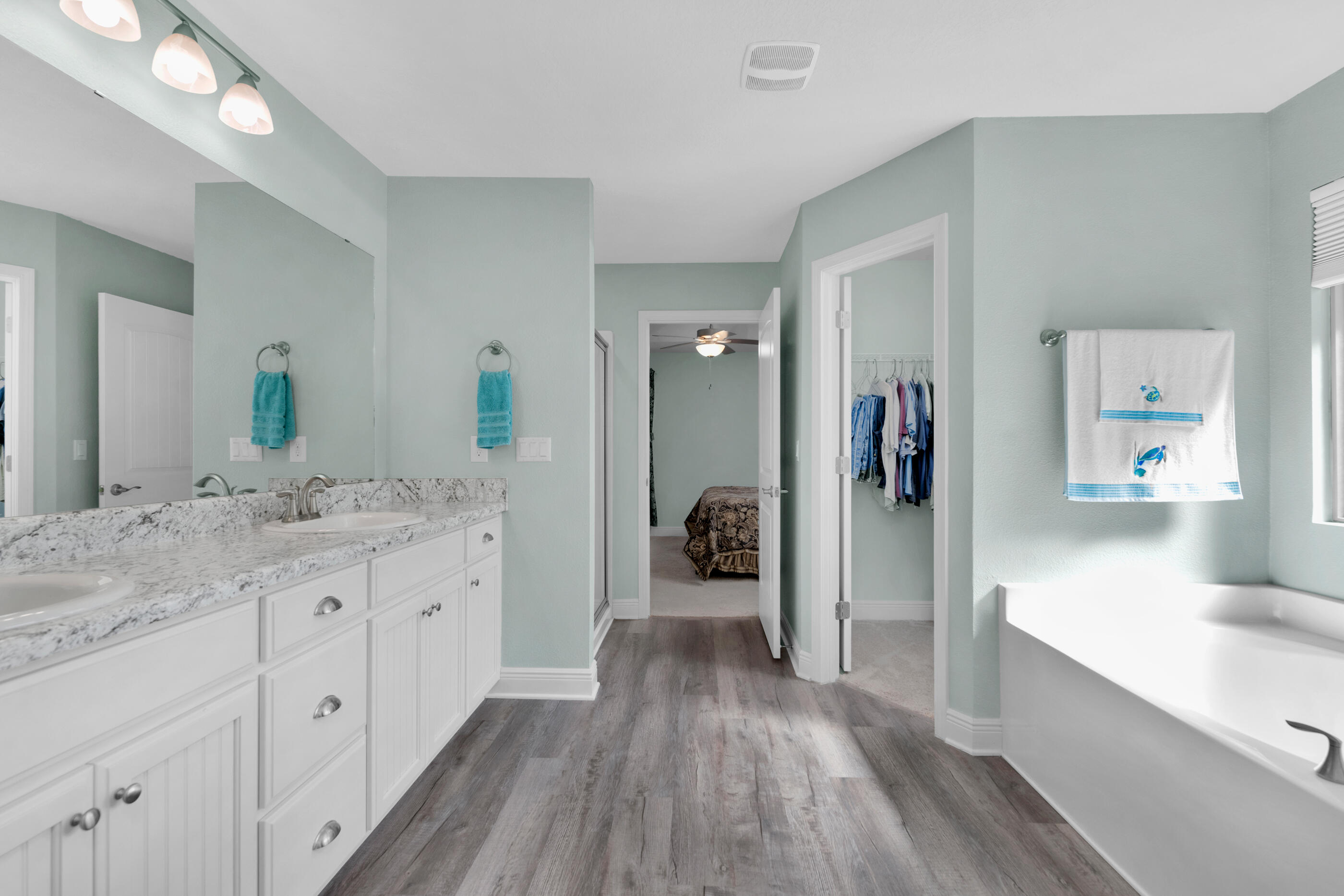 6042 Hidden Valley Road Crestview, FL 32539 - Photo 21 of 34 a spacious bathroom with a granite countertop sink shower and a mirror