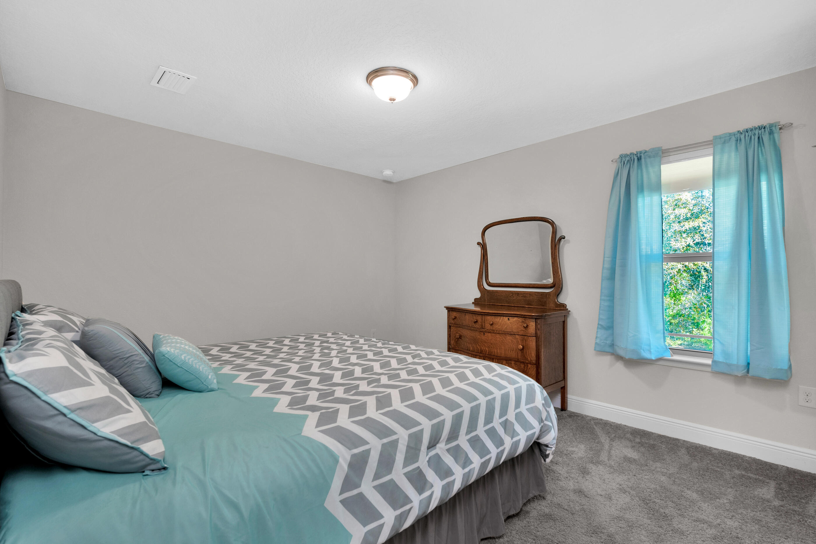 6042 Hidden Valley Road Crestview, FL 32539 - Photo 24 of 34 a bedroom with a bed and a window