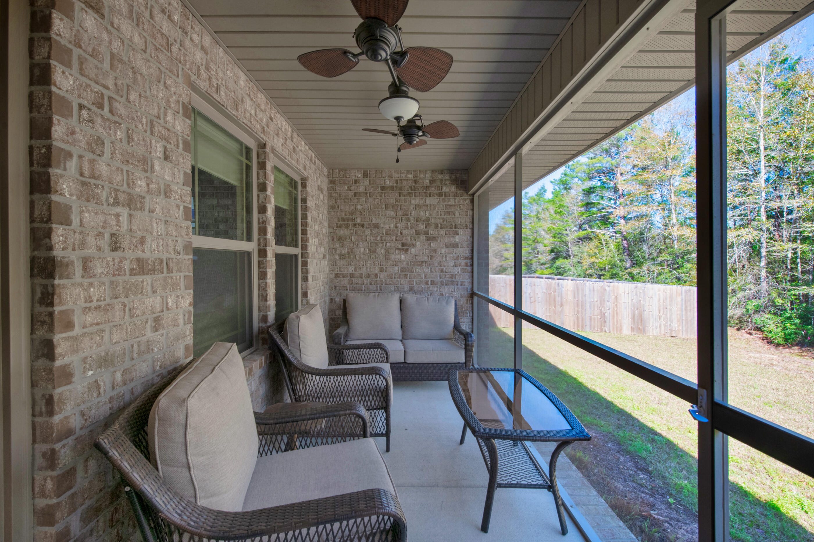 6042 Hidden Valley Road Crestview, FL 32539 - Photo 26 of 34 a view of a livingroom with furniture and a floor to ceiling window