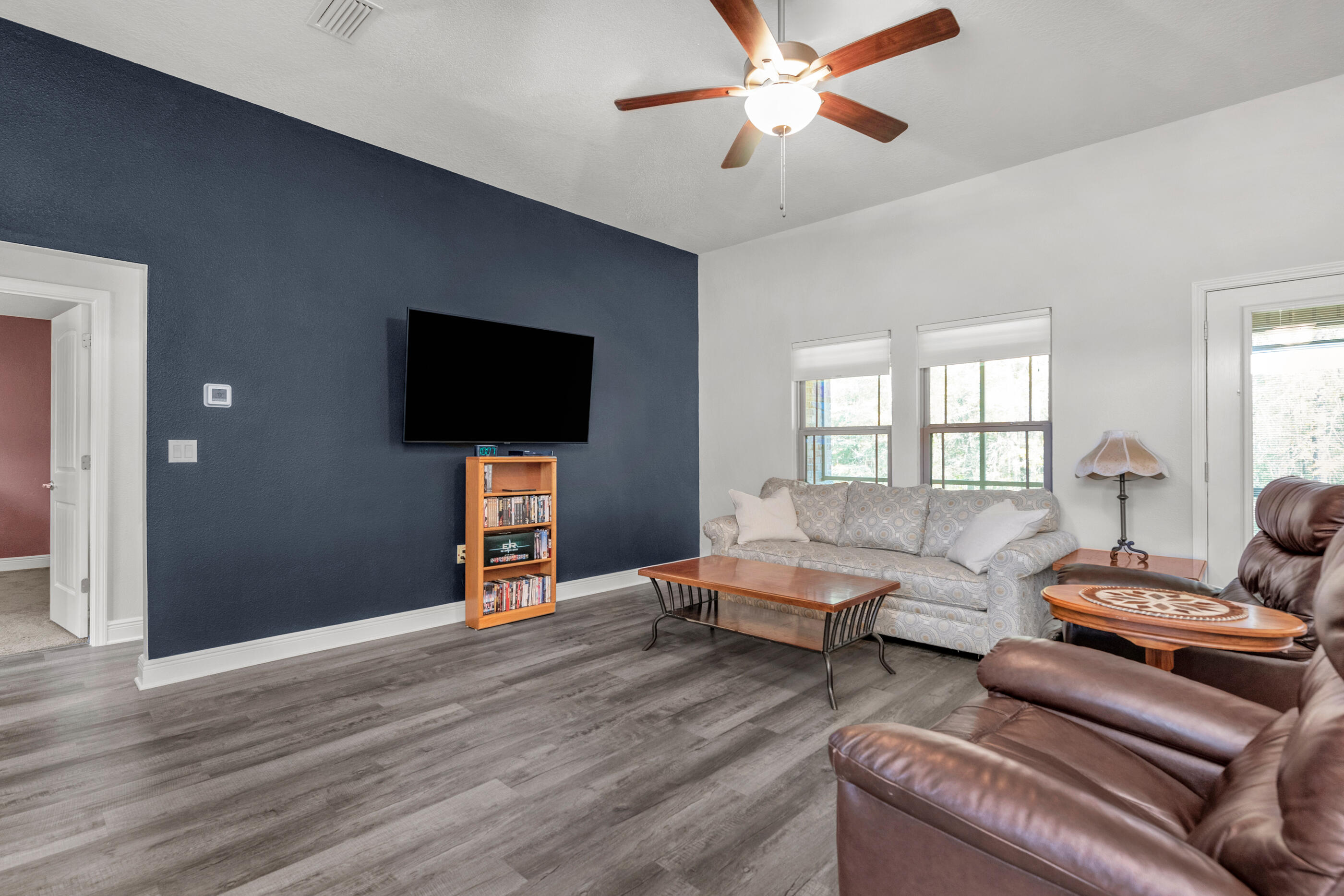 6042 Hidden Valley Road Crestview, FL 32539 - Photo 4 of 34 a living room with furniture and a flat screen tv
