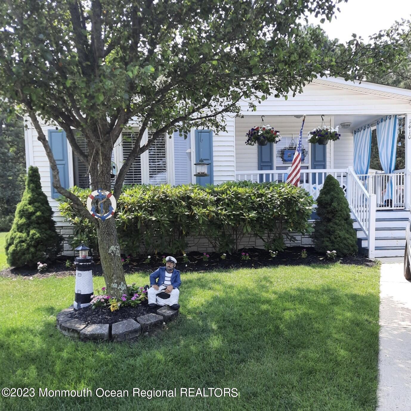 a front view of a house with a garden and plants