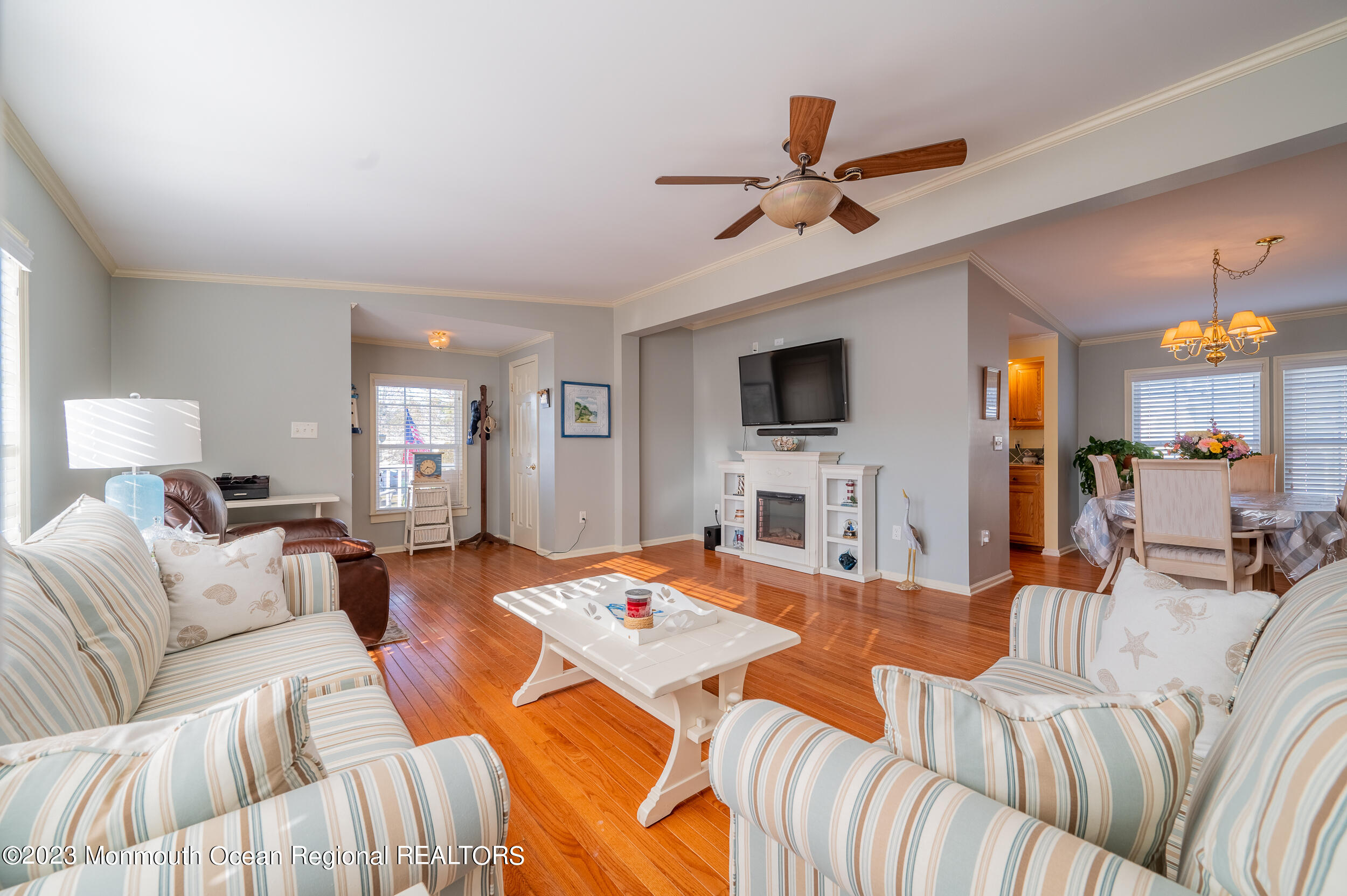 1410 Forest Way Whiting, NJ 08759 - Photo 11 of 34 a living room with furniture a flat screen tv and a chandelier