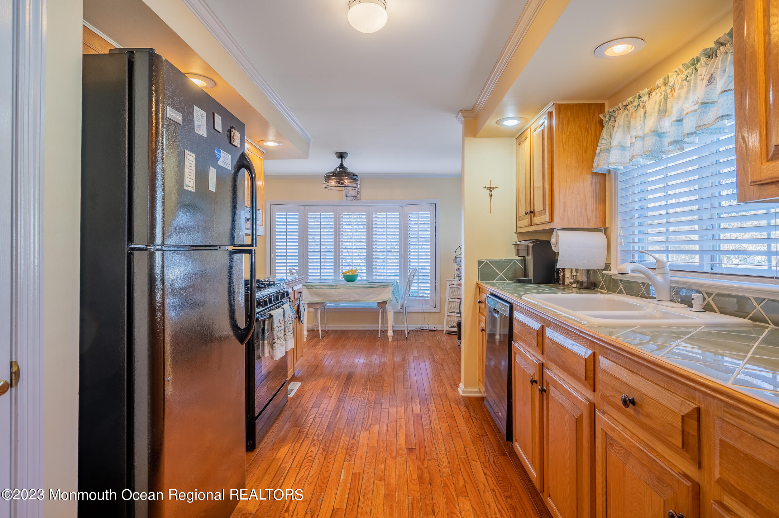 1410 Forest Way Whiting, NJ 08759 - Photo 18 of 34 a kitchen with kitchen island wooden floor center island and stainless steel appliances