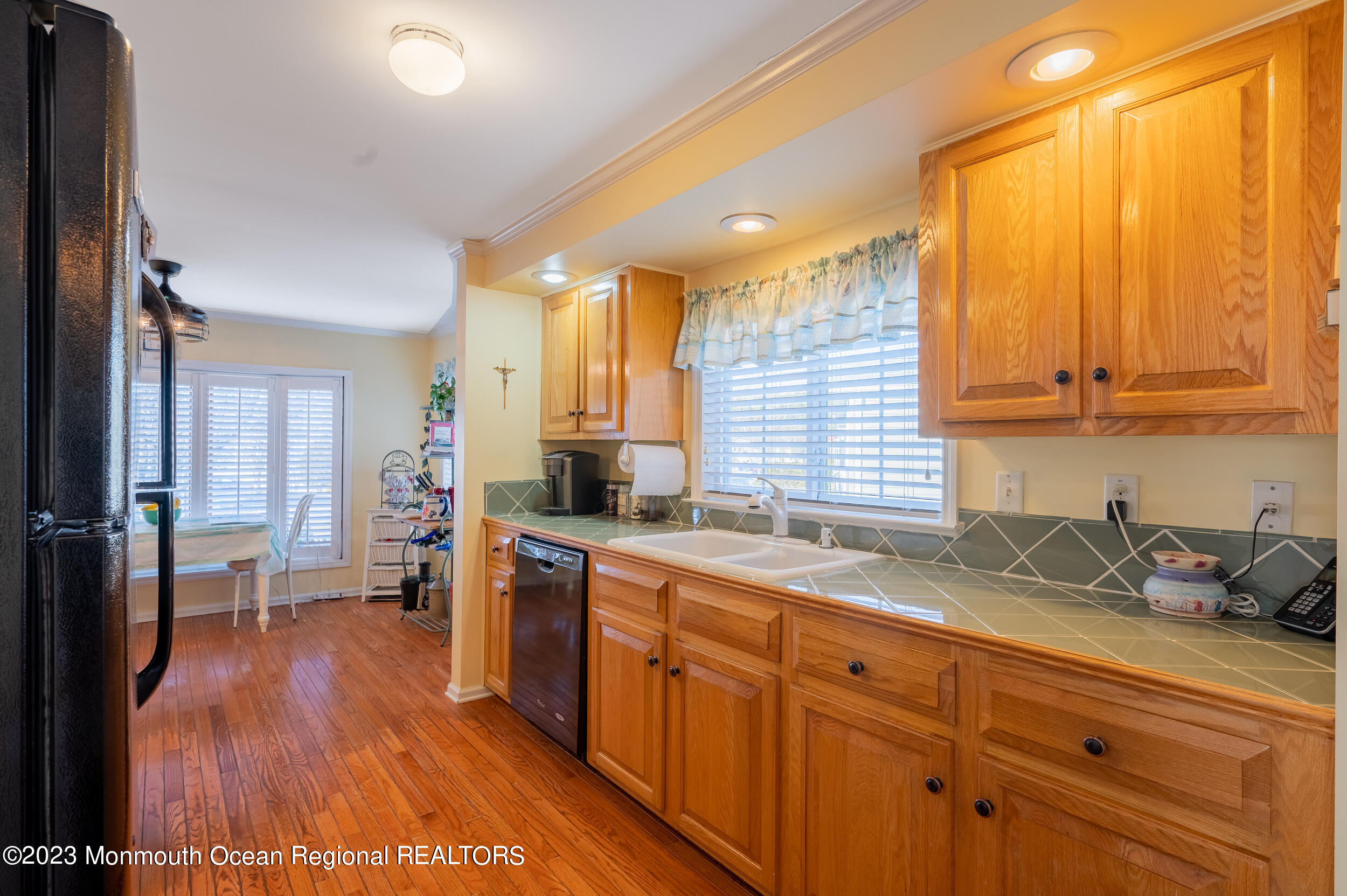 1410 Forest Way Whiting, NJ 08759 - Photo 19 of 34 a kitchen with a sink and wooden cabinets