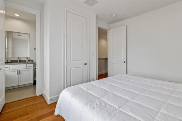 a bedroom with a bed and cabinets