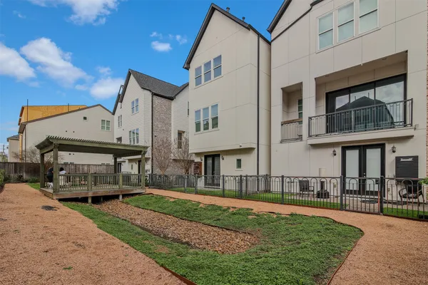 a front view of a building with a garden