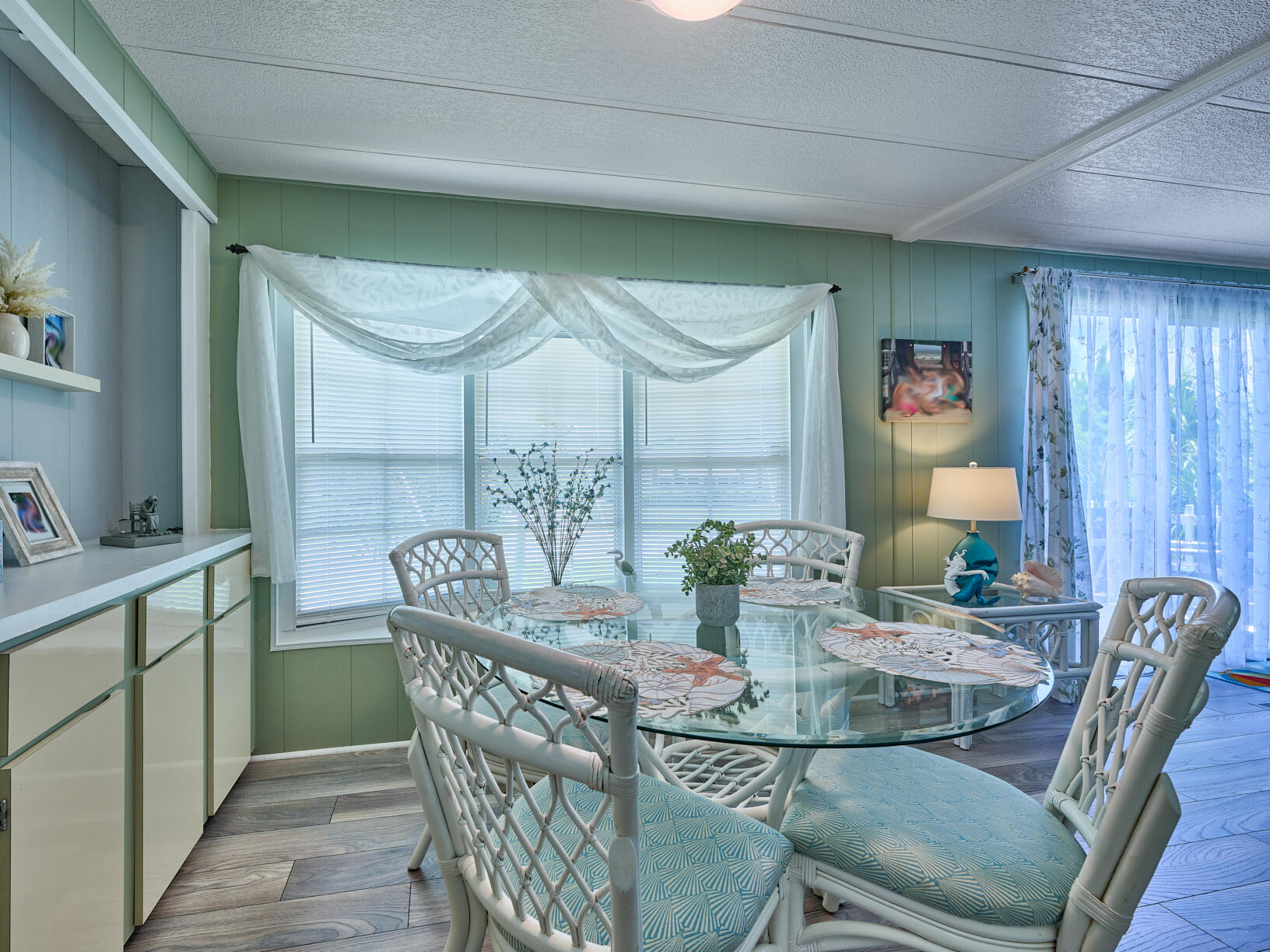 6977 Southeast Delegate Street Hobe Sound, FL 33455 - Photo 19 of 60 a dining room with furniture and wooden floor