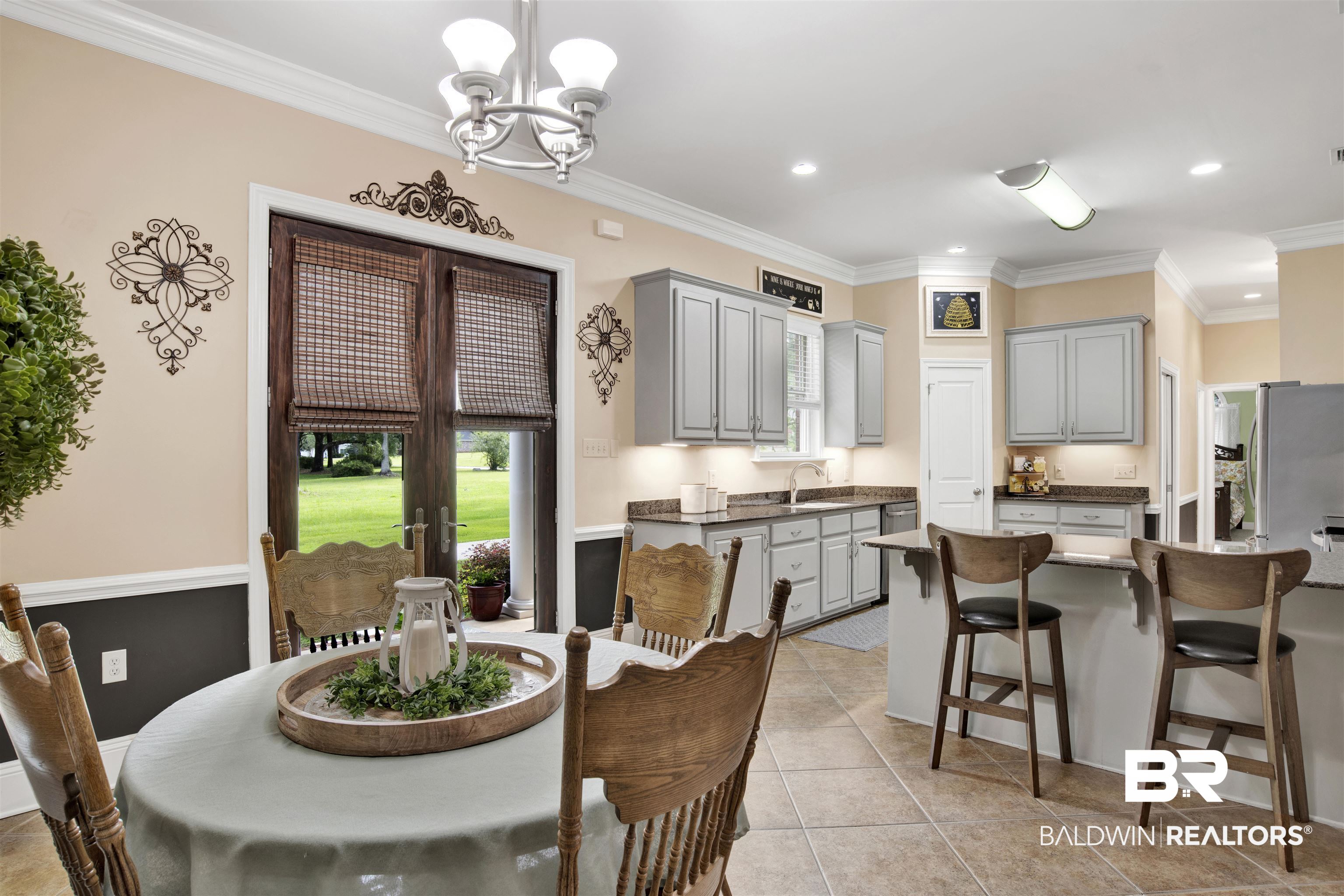 4340 Hamilton Oaks Lane Mobile, AL 36695 - Photo 15 of 51 Dining area with a notable chandelier, ornamental molding, sink, and light tile floors
