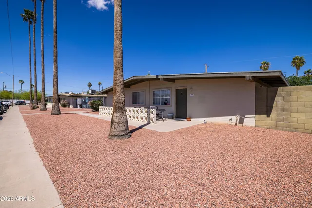 a backyard of a house with barbeque oven and outdoor seating