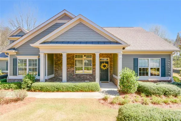 front view of a brick house with a yard