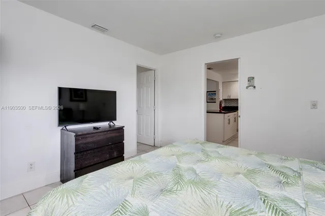 a bedroom with a bed and a flat screen tv