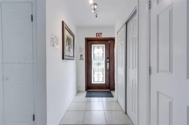 a view of a hallway with windows and closet