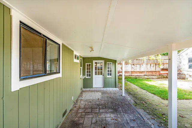 a view of a house with a yard and porch