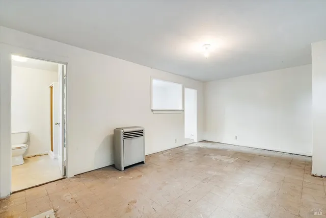 an empty room with windows and closet