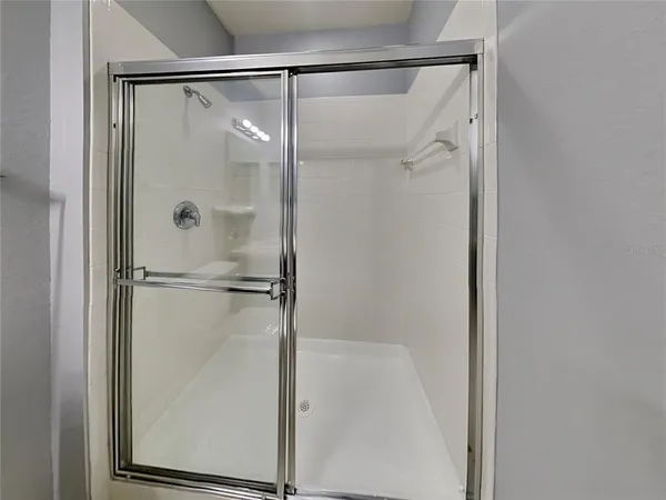 a bathroom with a glass shower door