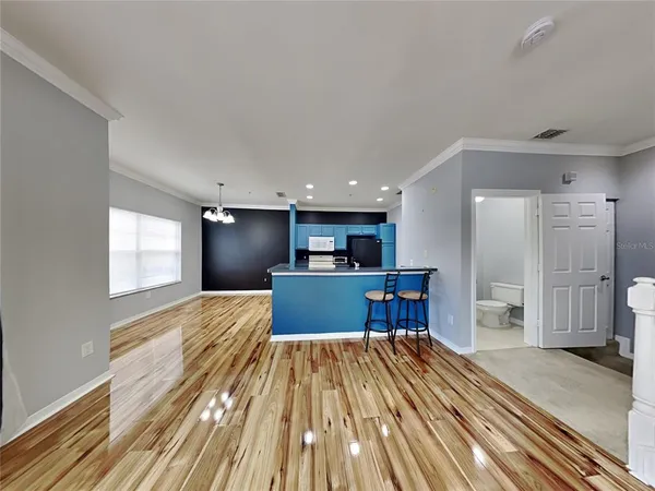 a view of a kitchen with a sink and a refrigerator
