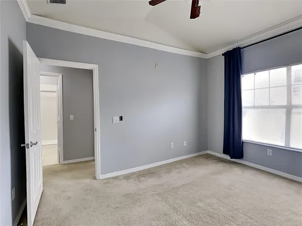 an empty room with windows and closet