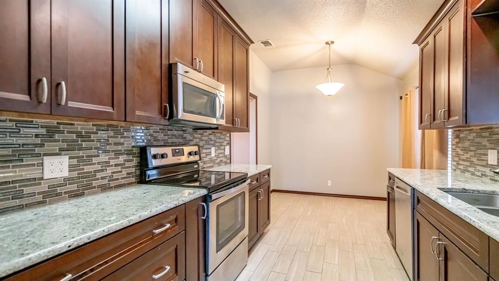 4018 View Point Drive Granbury, TX 76048 - Photo 13 of 38 Galley kitchen with stainless appliances