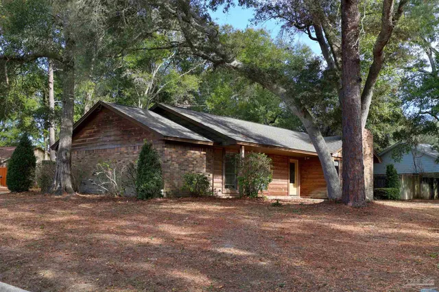 a wooden bench sitting in front of a house