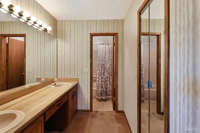 a bathroom with a double vanity sink and a mirror